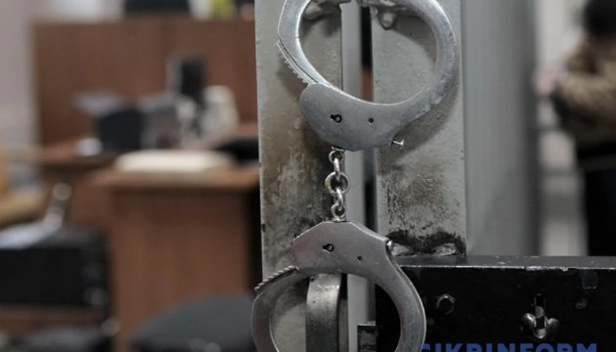 Силует затриманого на тлі будівлі польського суду